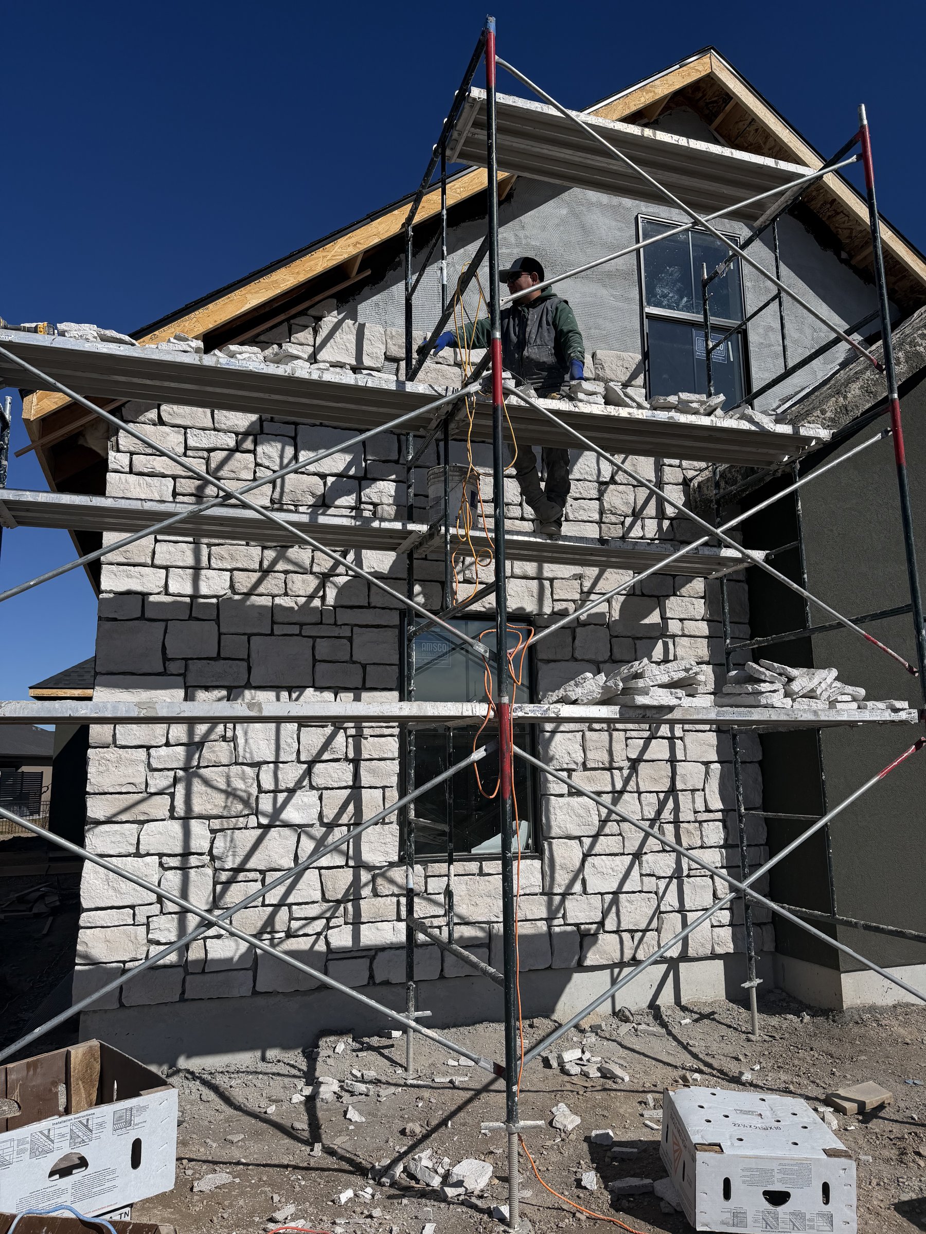 Stone exterior work and scaffolding during build