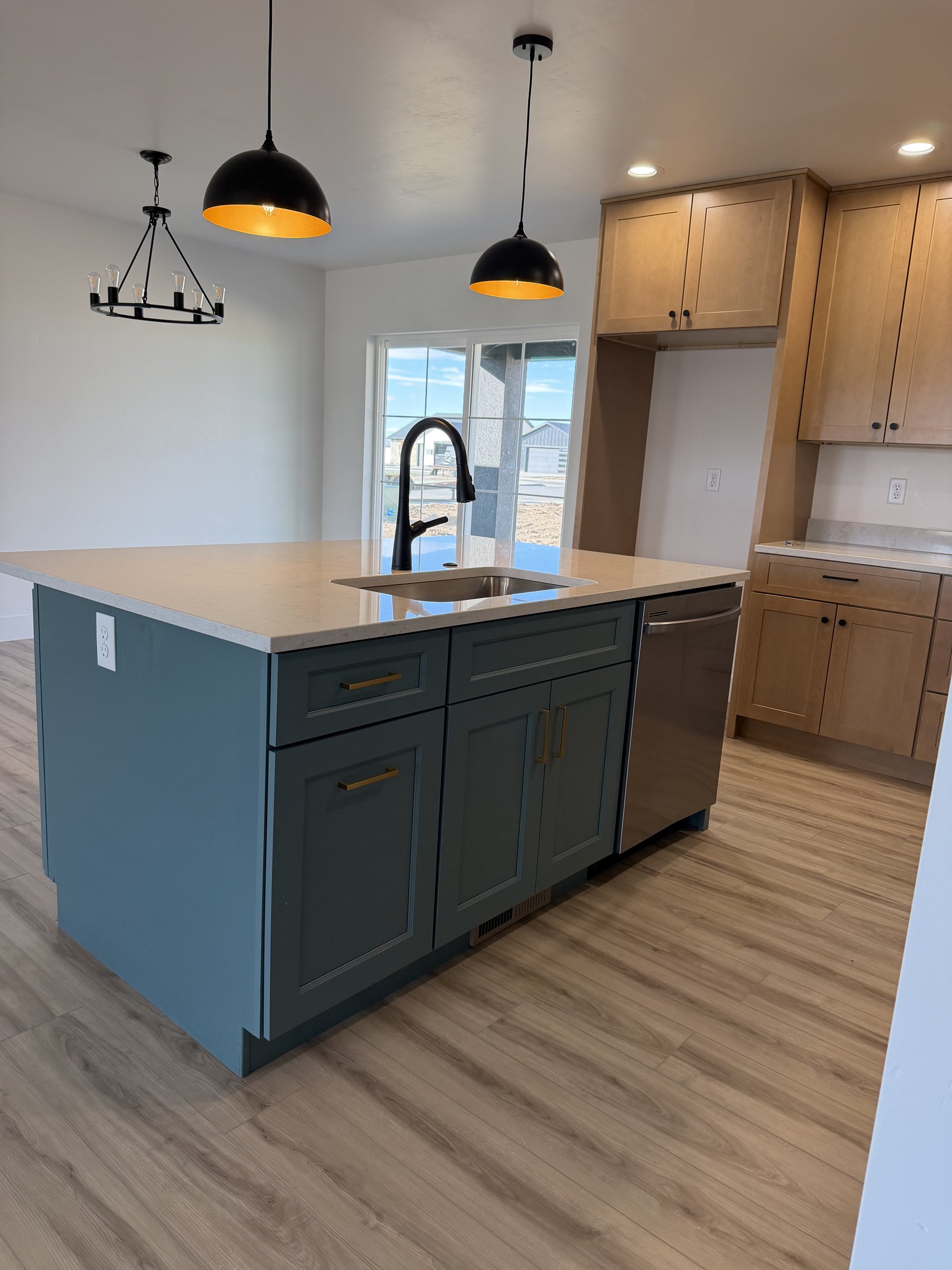 Navy kitchen cabinetry with wood-look flooring