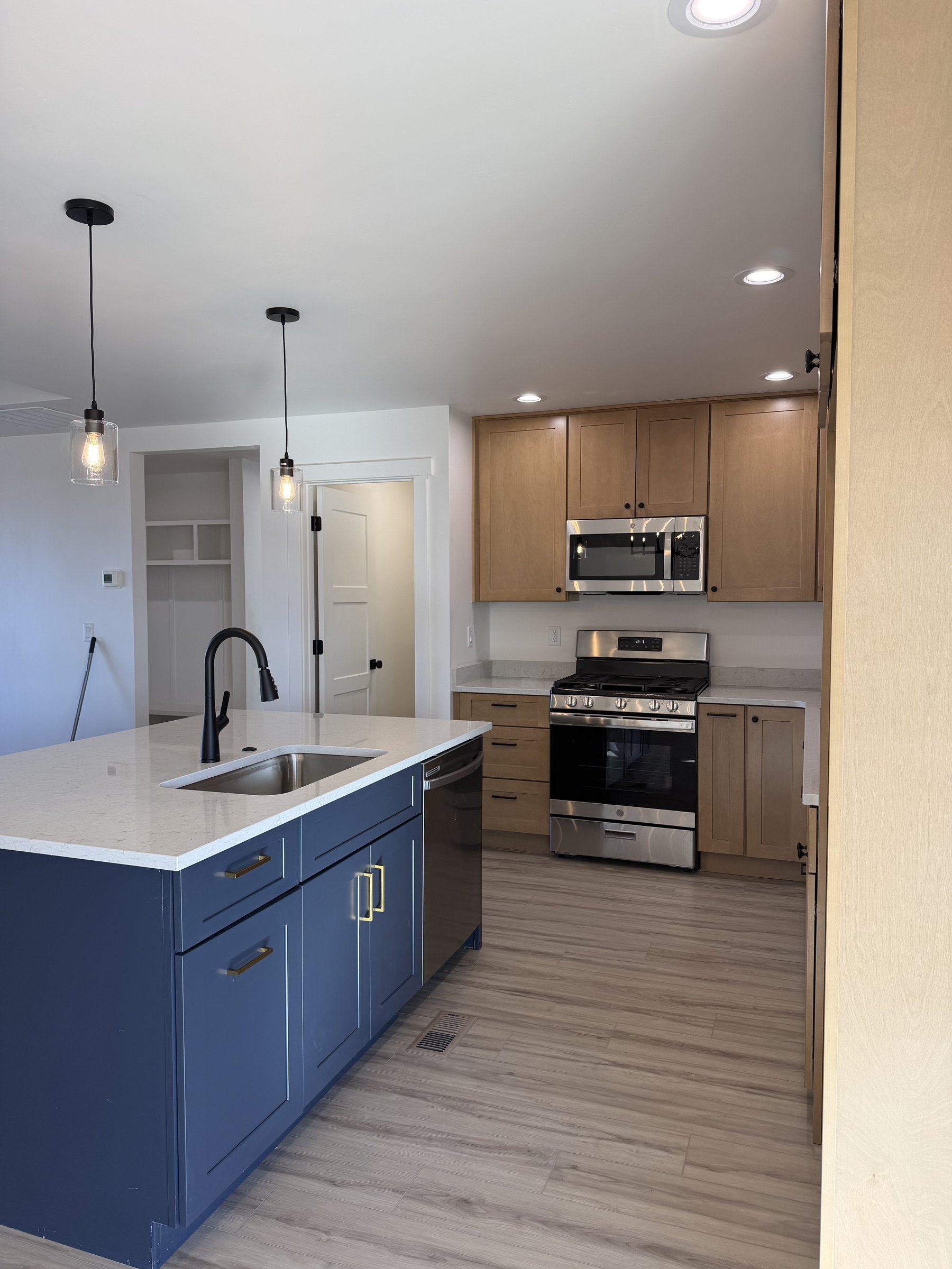 Modern kitchen with navy island and gold pulls