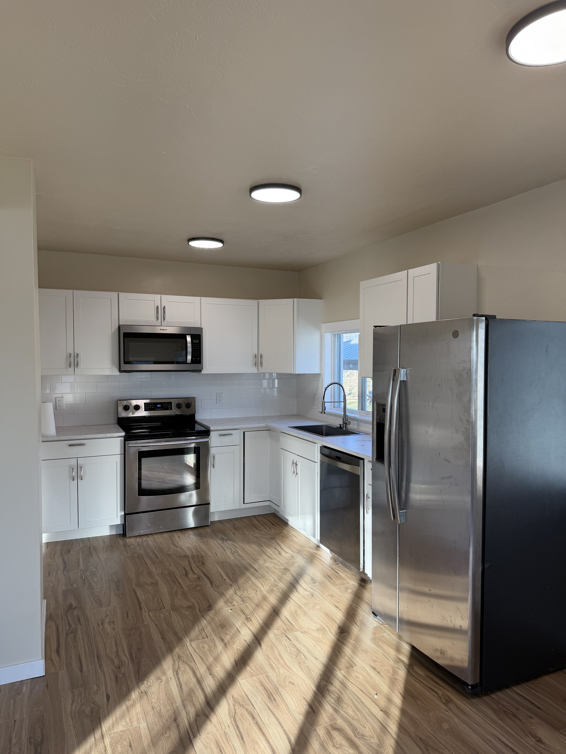 White modern kitchen with stainless appliances