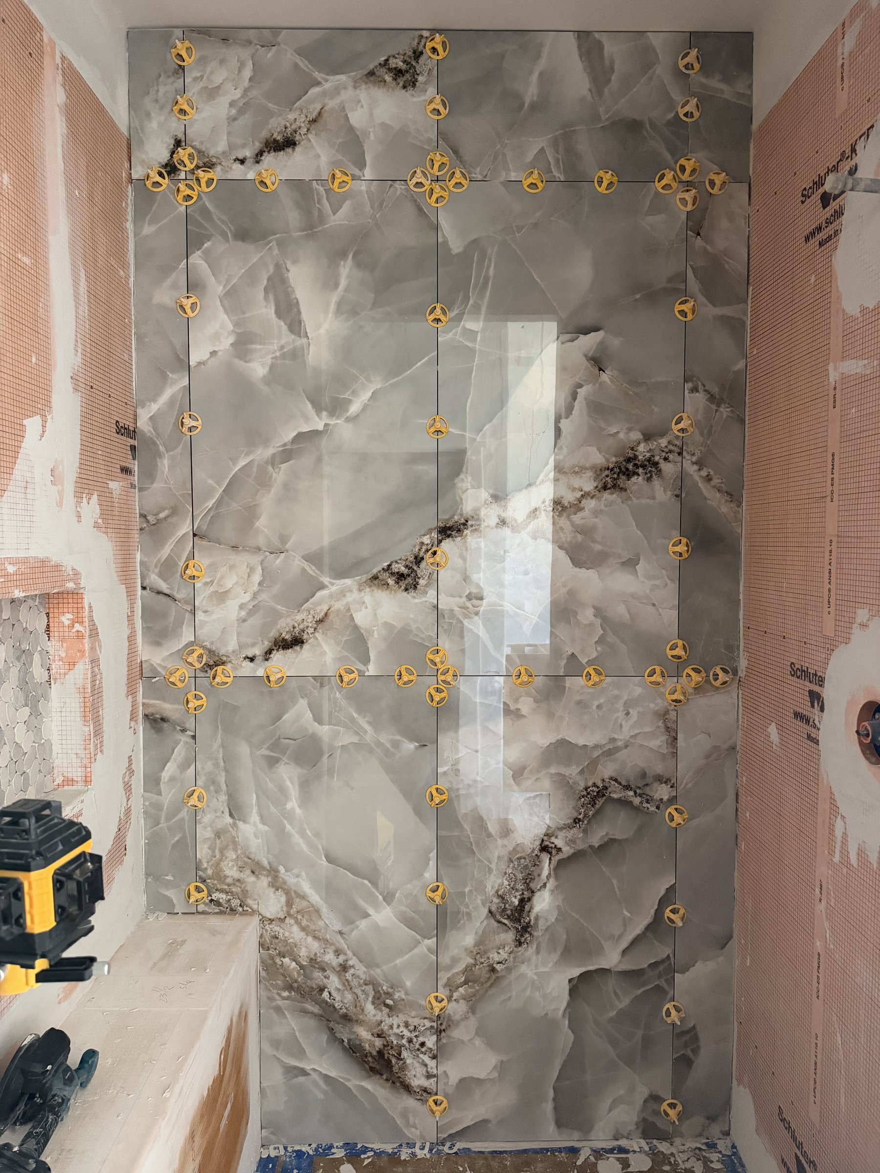 Large format marble tile install in progress
